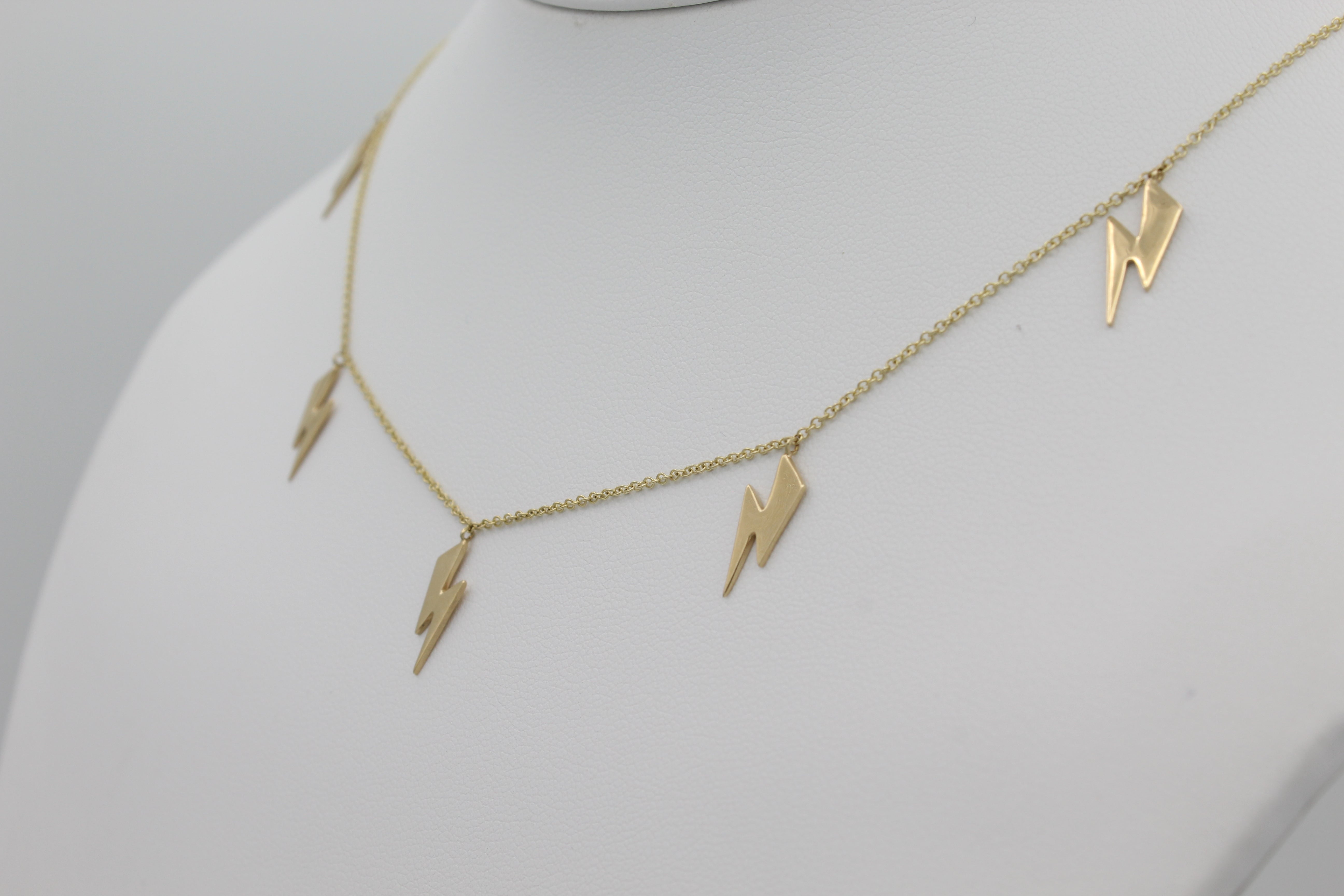 14k Yellow Gold Lightning Bolt Five Station Necklace, close-up right angle view of necklace displayed on a mannequin.