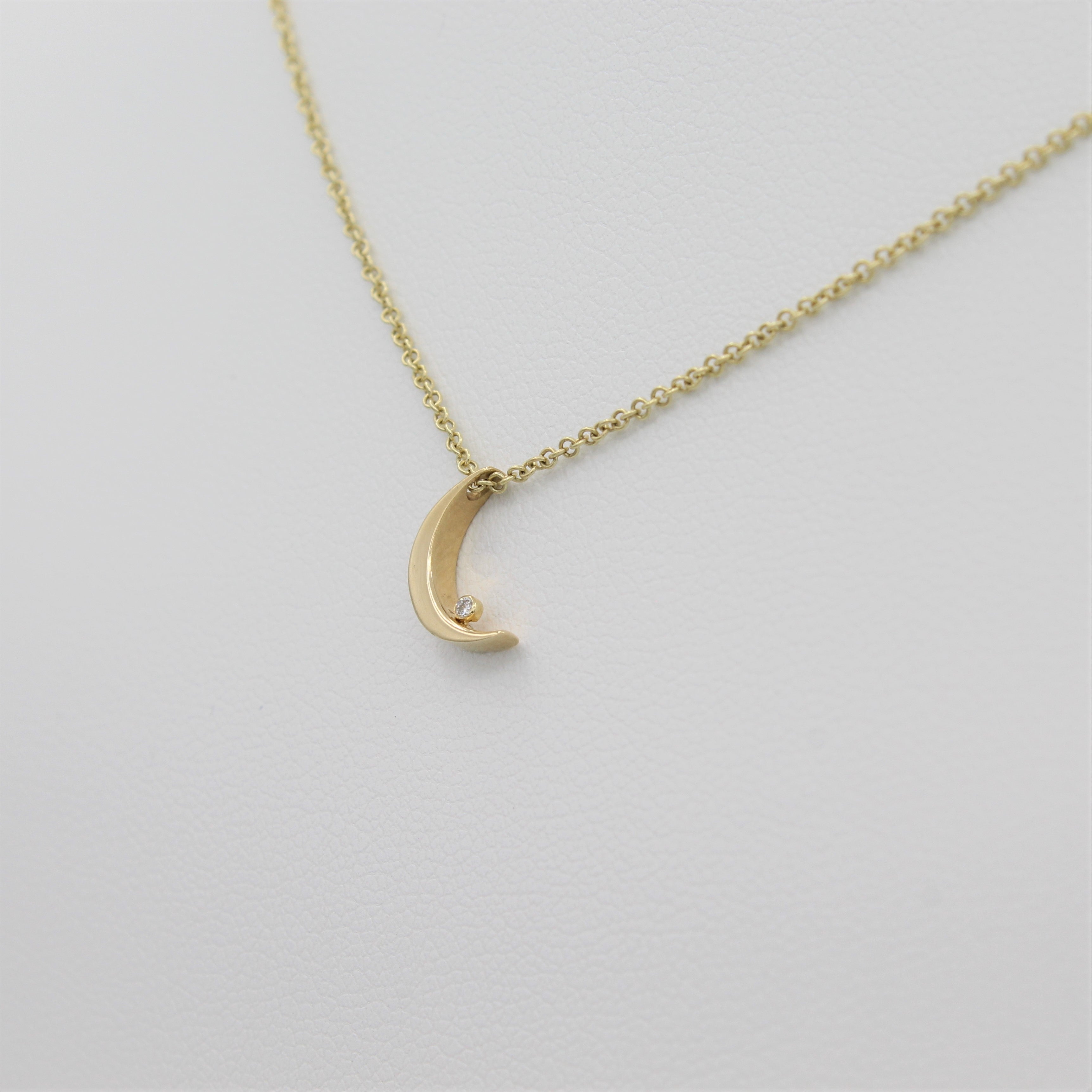 14k Yellow Gold Crescent Moon with Diamond Pendant, right angle view of necklace displayed on mannequin. 