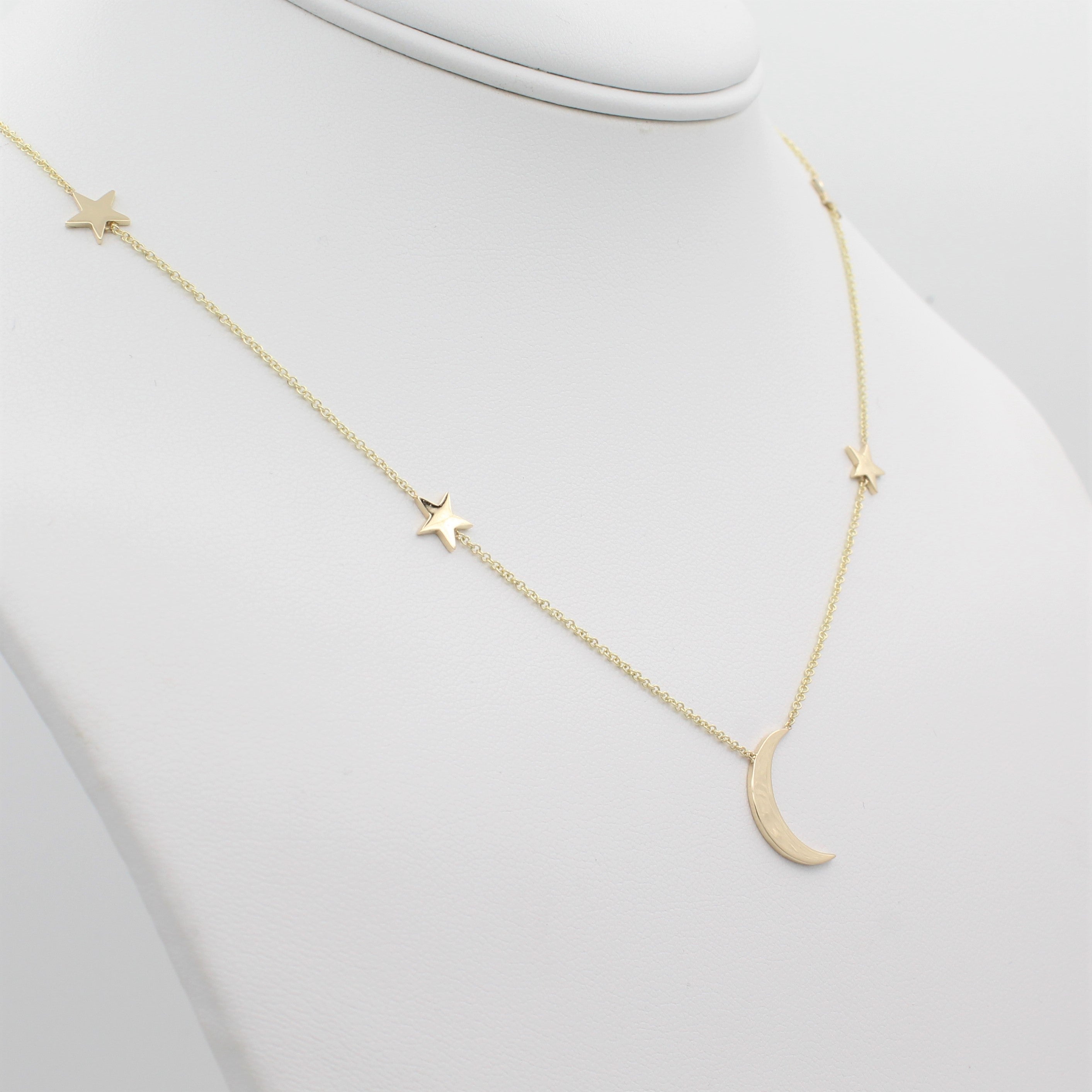 14k Yellow Gold Shoot for the Moon Station Necklace, left angle view of necklace displayed on mannequin neckline.