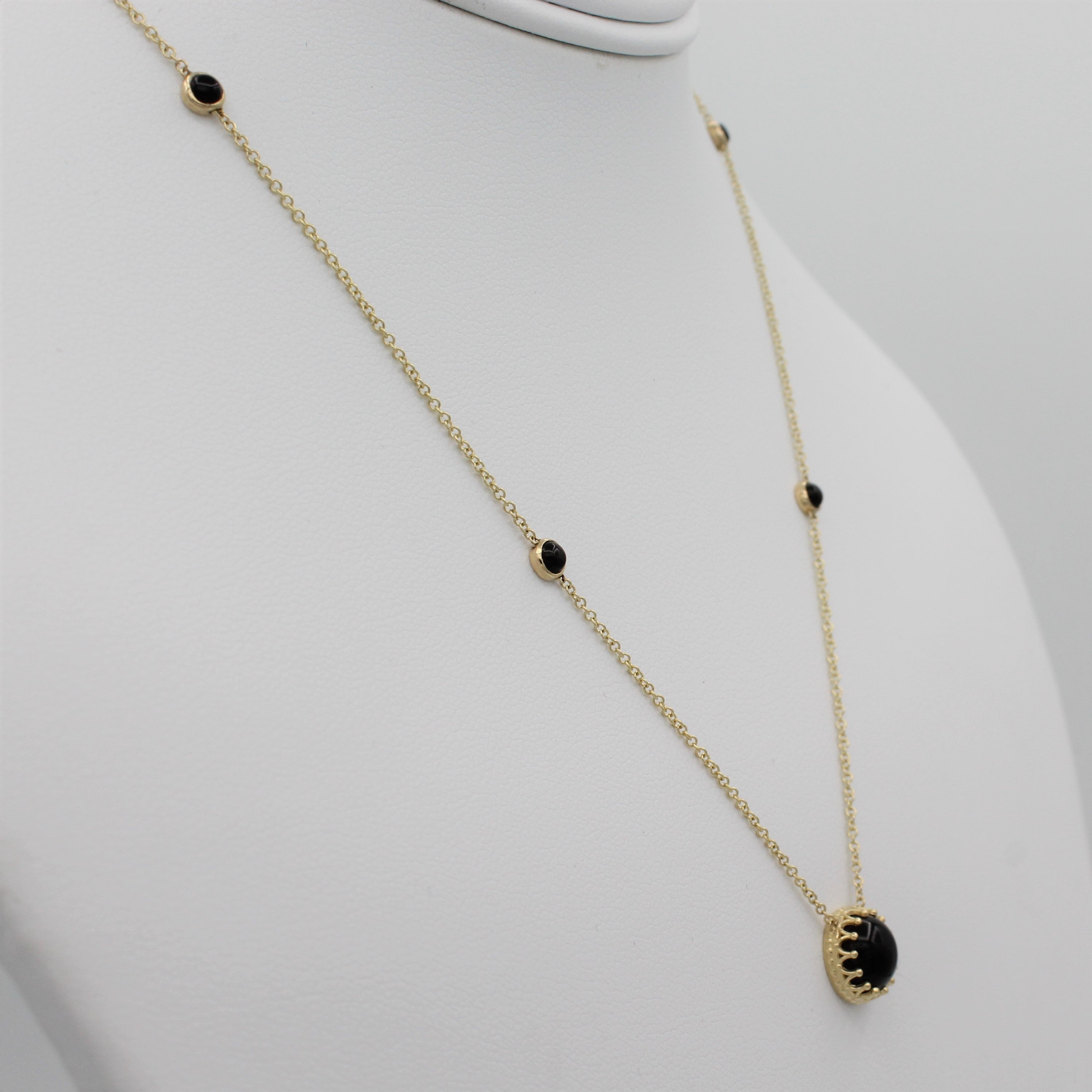 14k Yellow Gold Bewitched Black Onyx Station Necklace, left angle view of necklace displayed on a mannequin. 