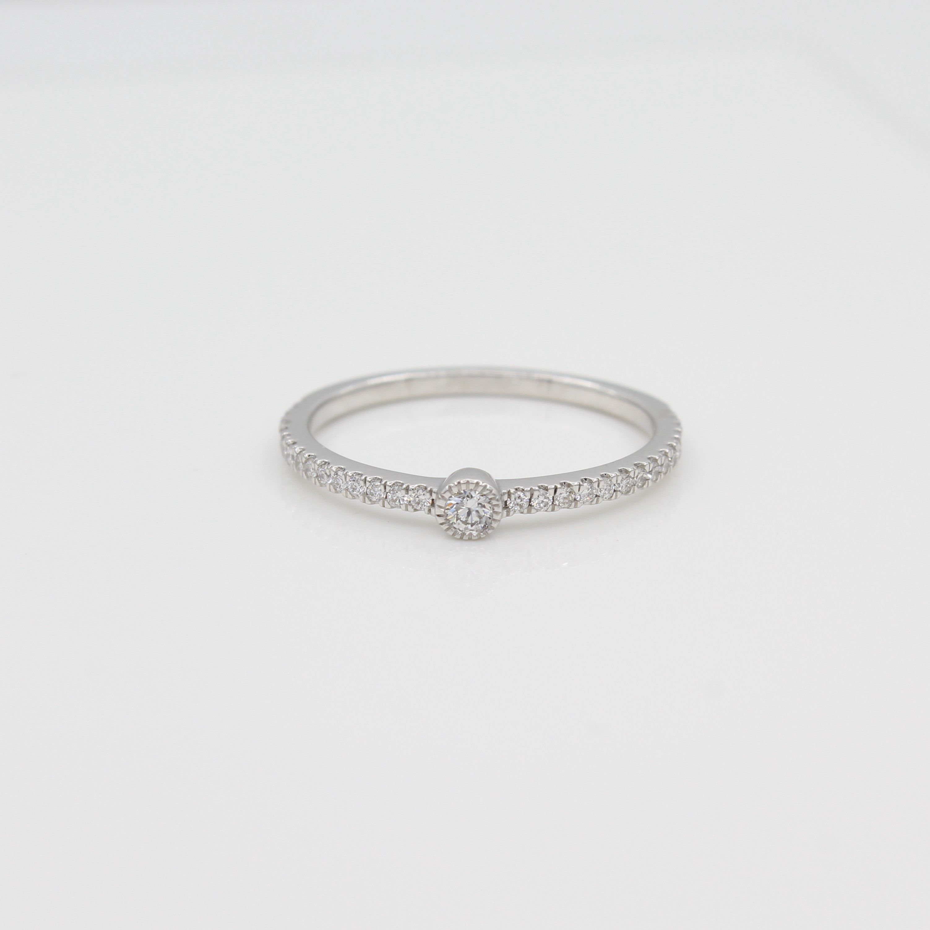 14k White Gold Single Bezel-Set Diamond Station Ring with Micro-Pave Band, front view.