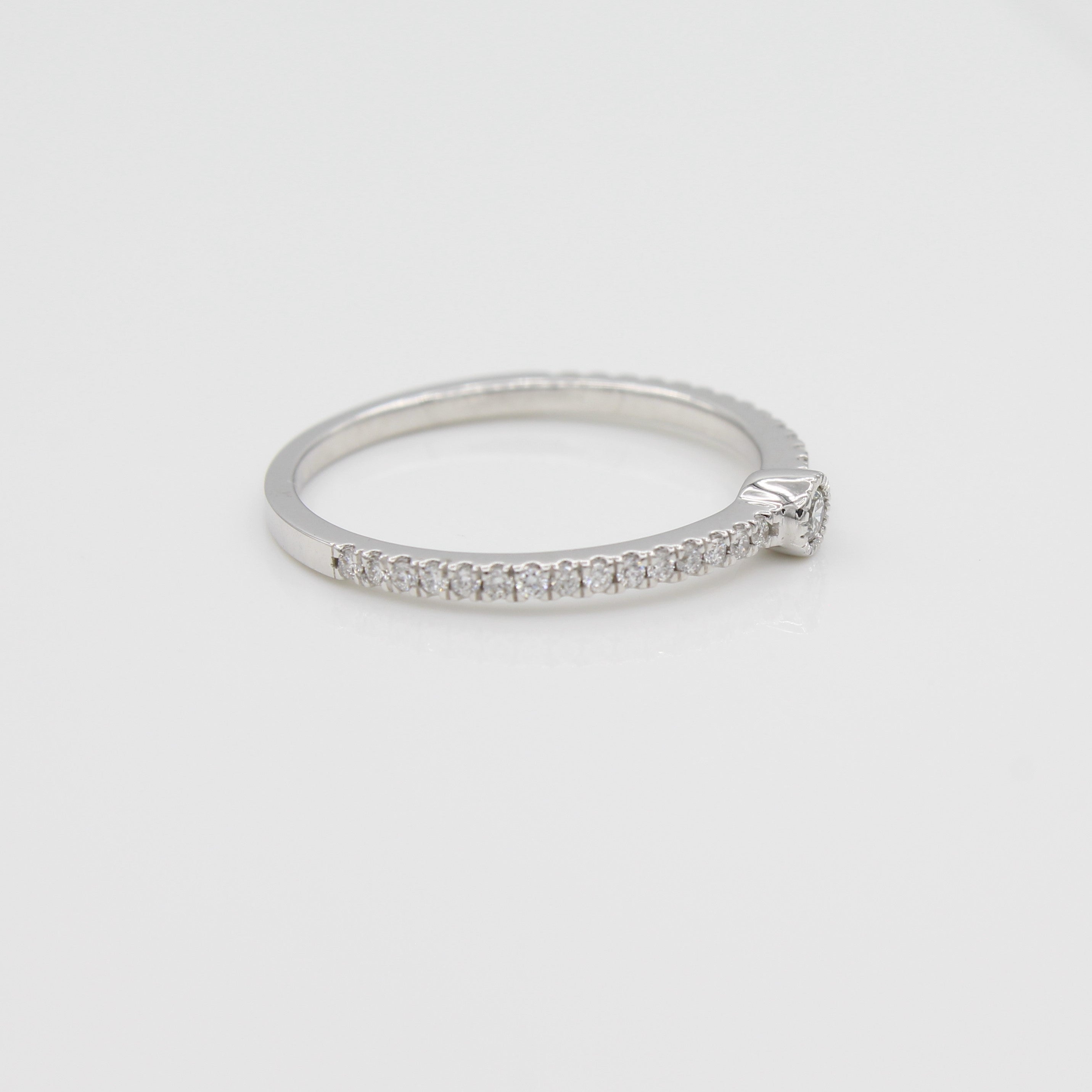 14k White Gold Single Bezel-Set Diamond Station Ring with Micro-Pave Band, side view from left.