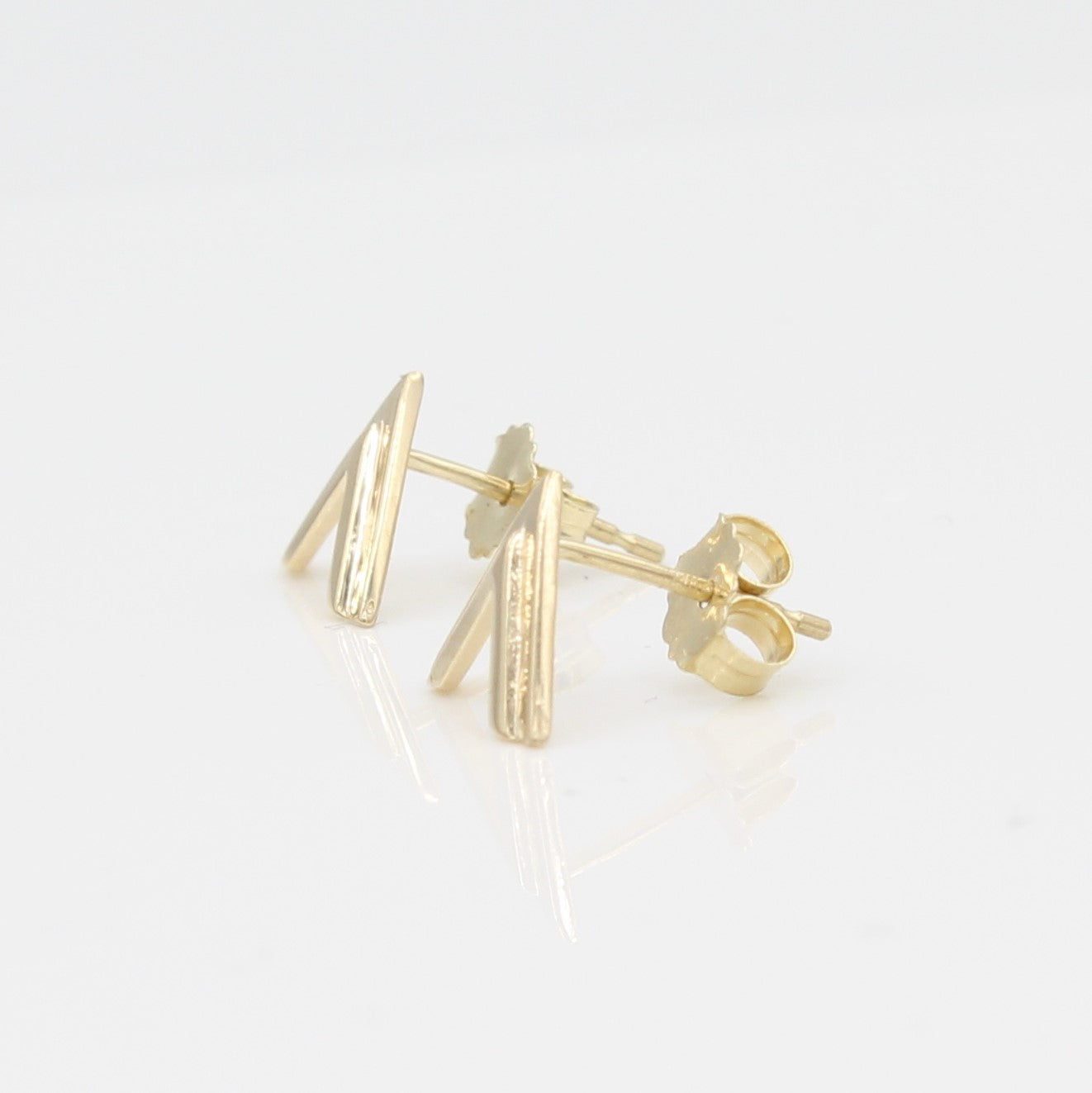 14k Yellow Gold Double Chevron Earrings, side view from right with a peak at the earring's posts and backs. 