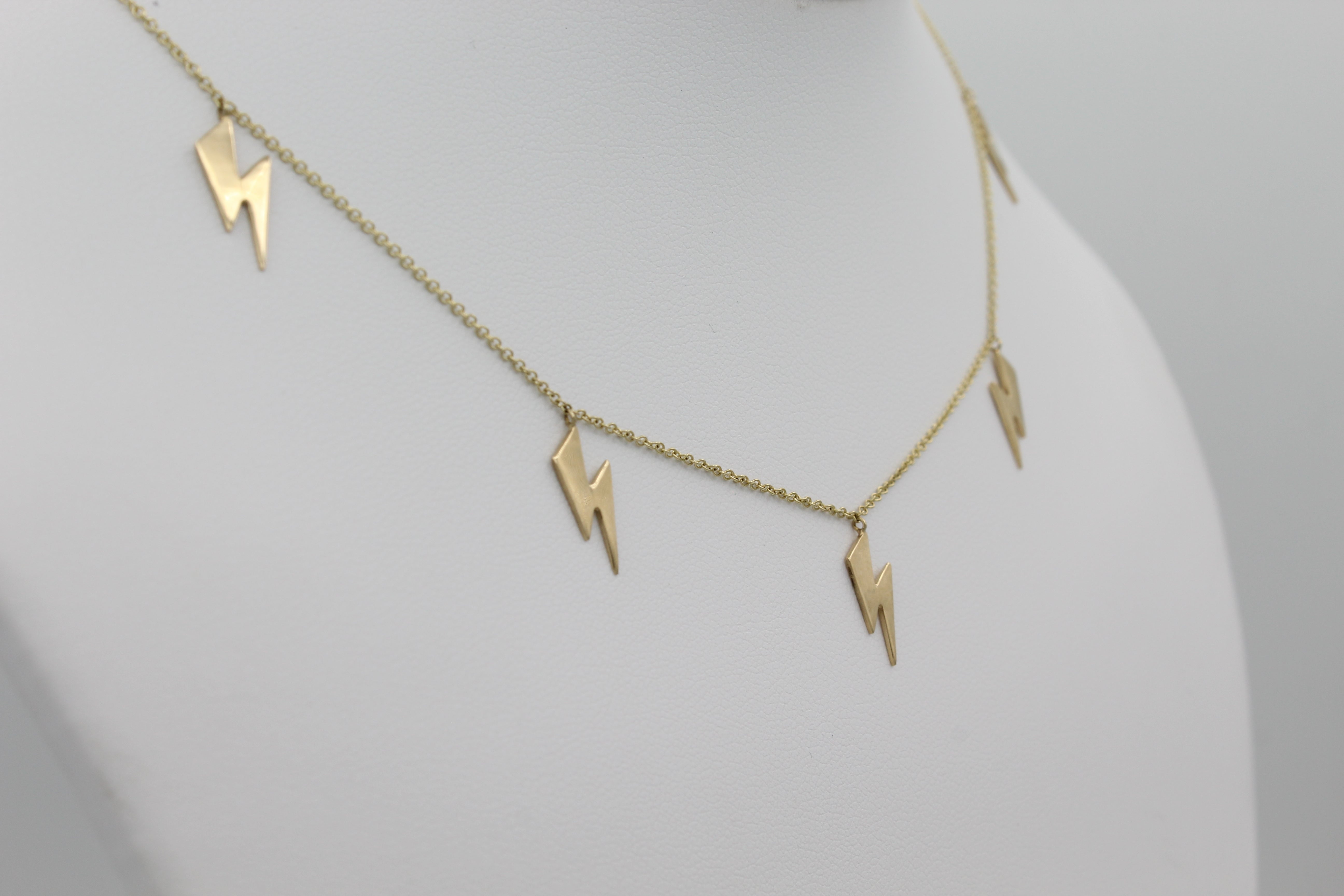 14k Yellow Gold Lightning Bolt Five Station Necklace, close-up left angle view of necklace displayed on a mannequin.