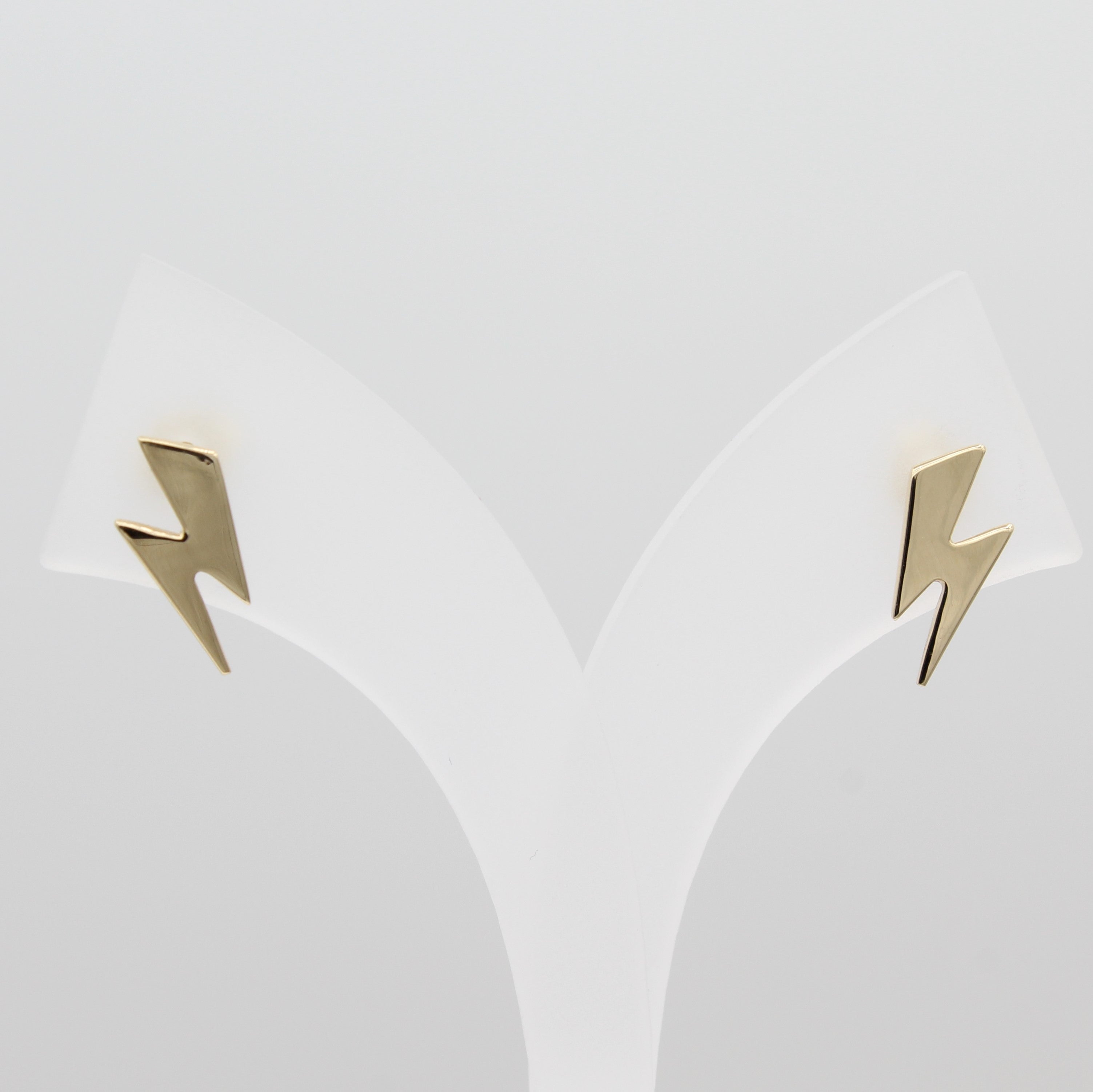 14k Yellow Gold Striking Lightning Bolt Earrings, front view of earrings on a white jewelry display. 