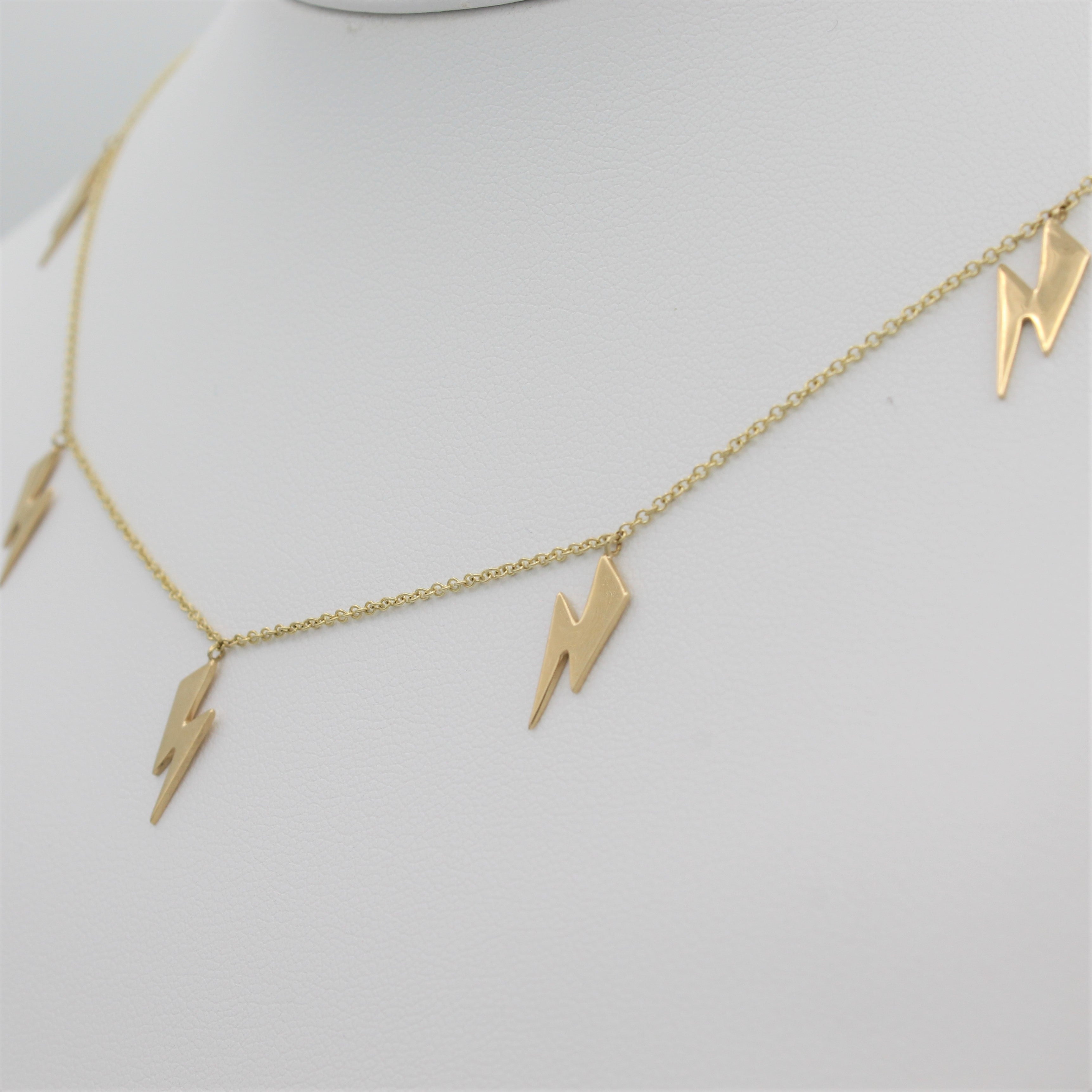 14k Yellow Gold Lightning Bolt Five Station Necklace, close-up right angle view of necklace displayed on a mannequin. 