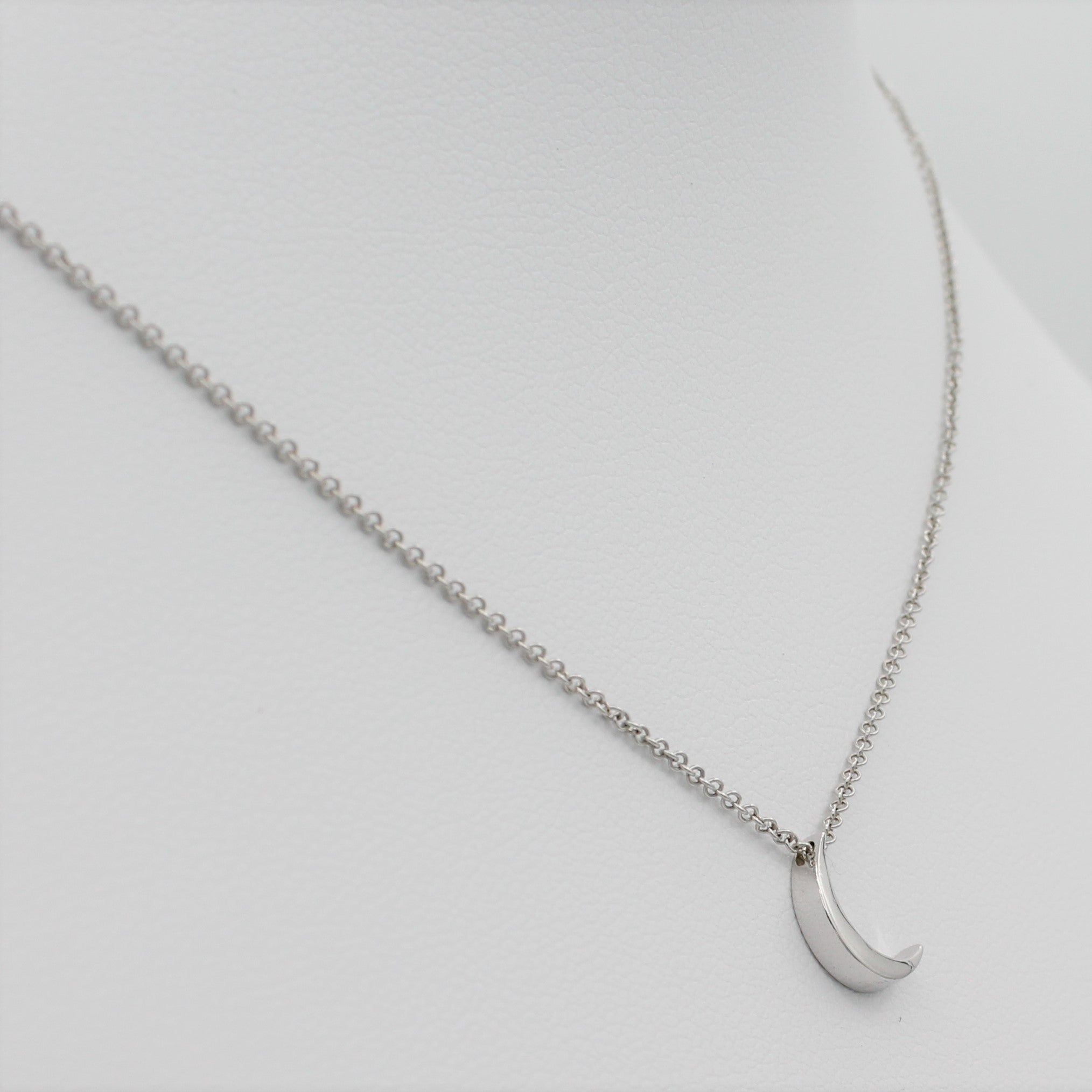 14k White Gold Crescent Moon Pendant, left angle view of necklace displayed on a mannequin.