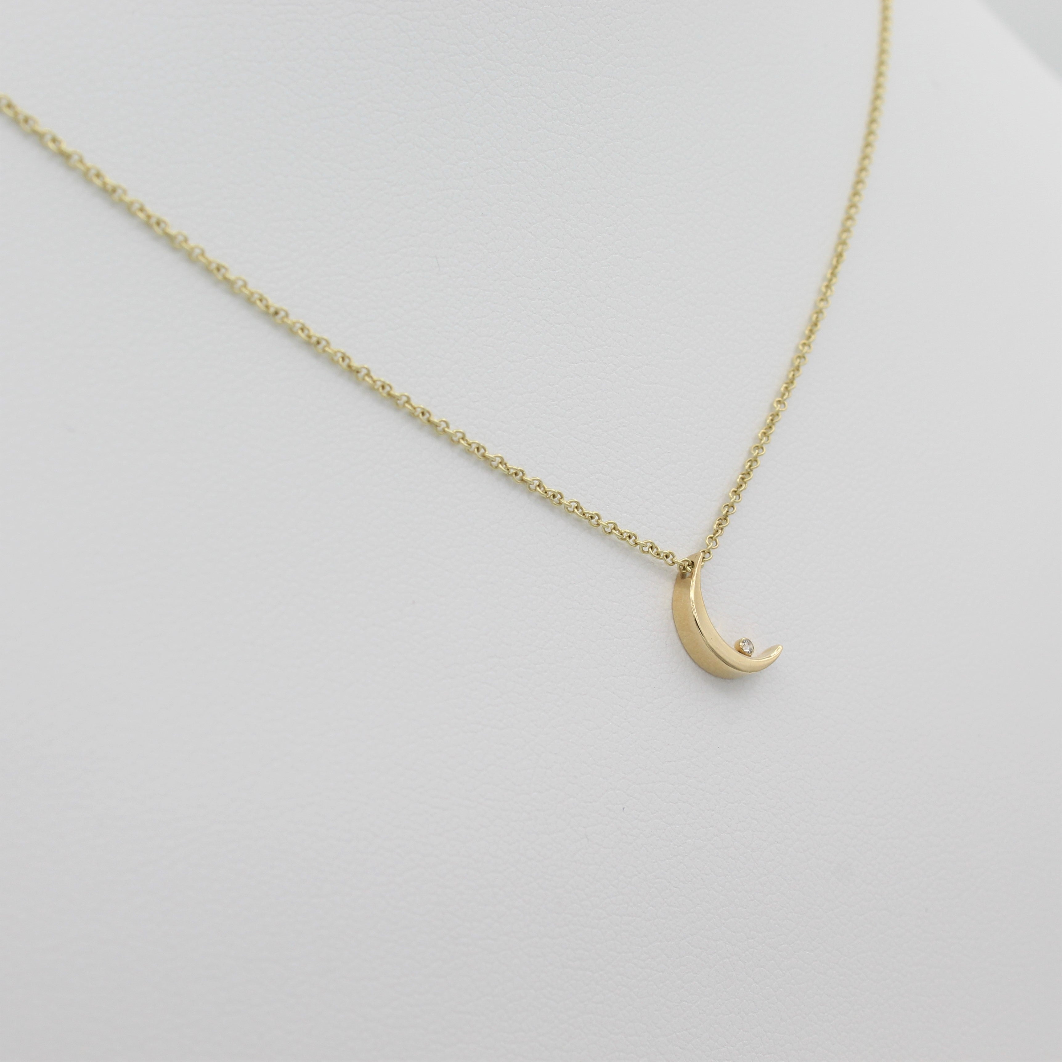 14k Yellow Gold Crescent Moon with Diamond Pendant, left angle view of necklace displayed on mannequin. 