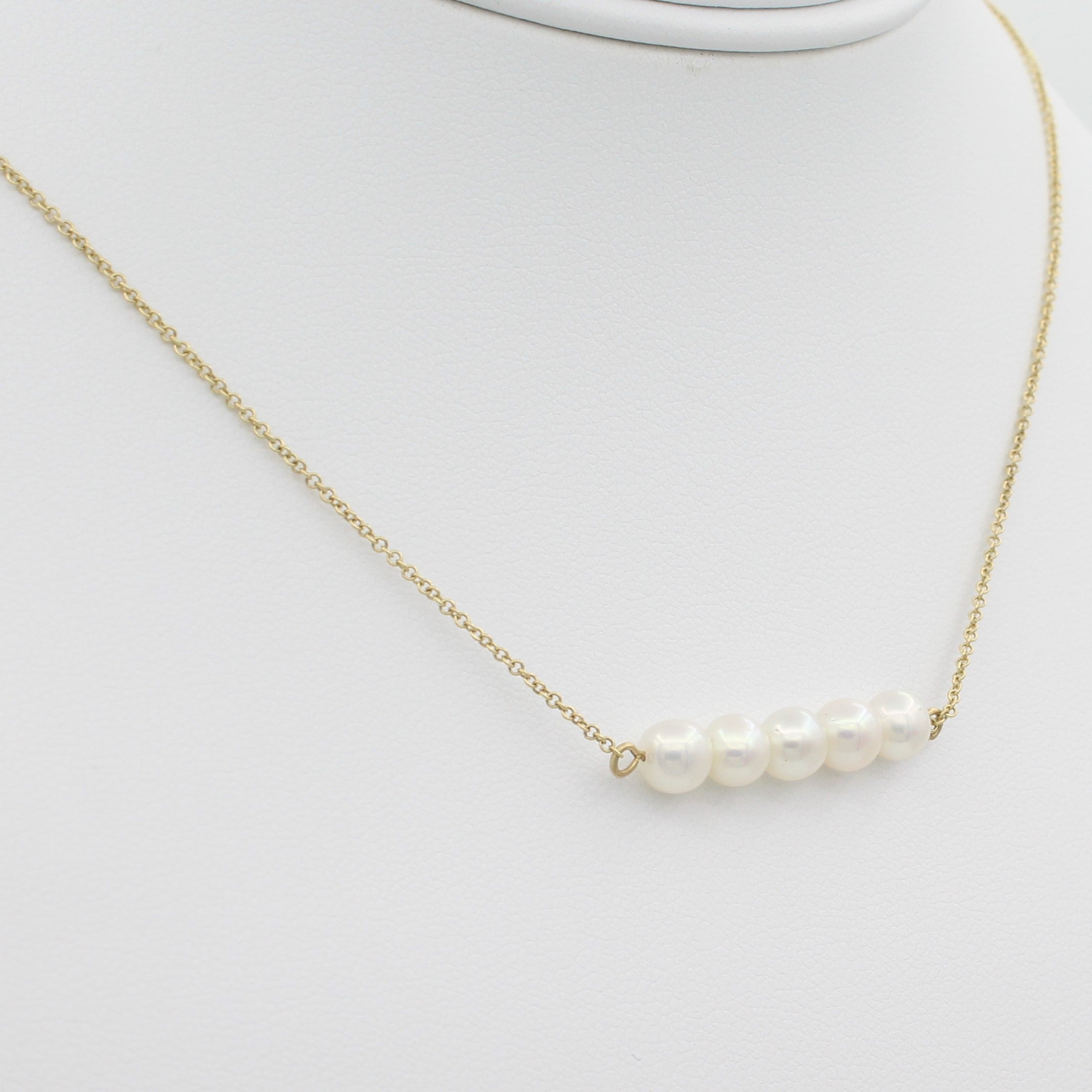 14k Yellow Gold Cultured Freshwater Pearl Bar Pendant, close-up left angle view of pearl bar displayed on a mannequin.