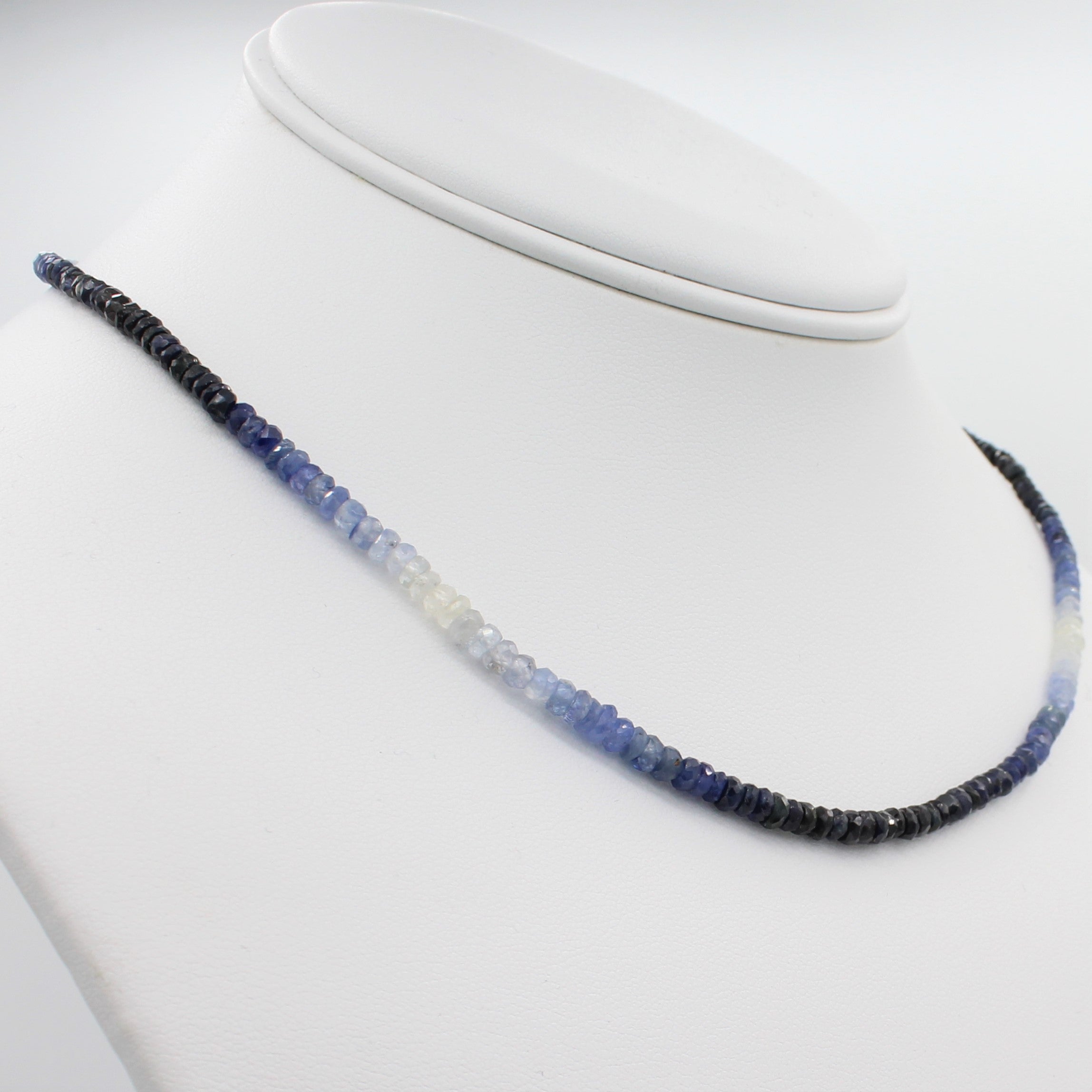 Beauty in Blue 40CT Adjustable Ombre Sapphire Choker Necklace, left angle view of necklace displayed on a mannequin neckline. 