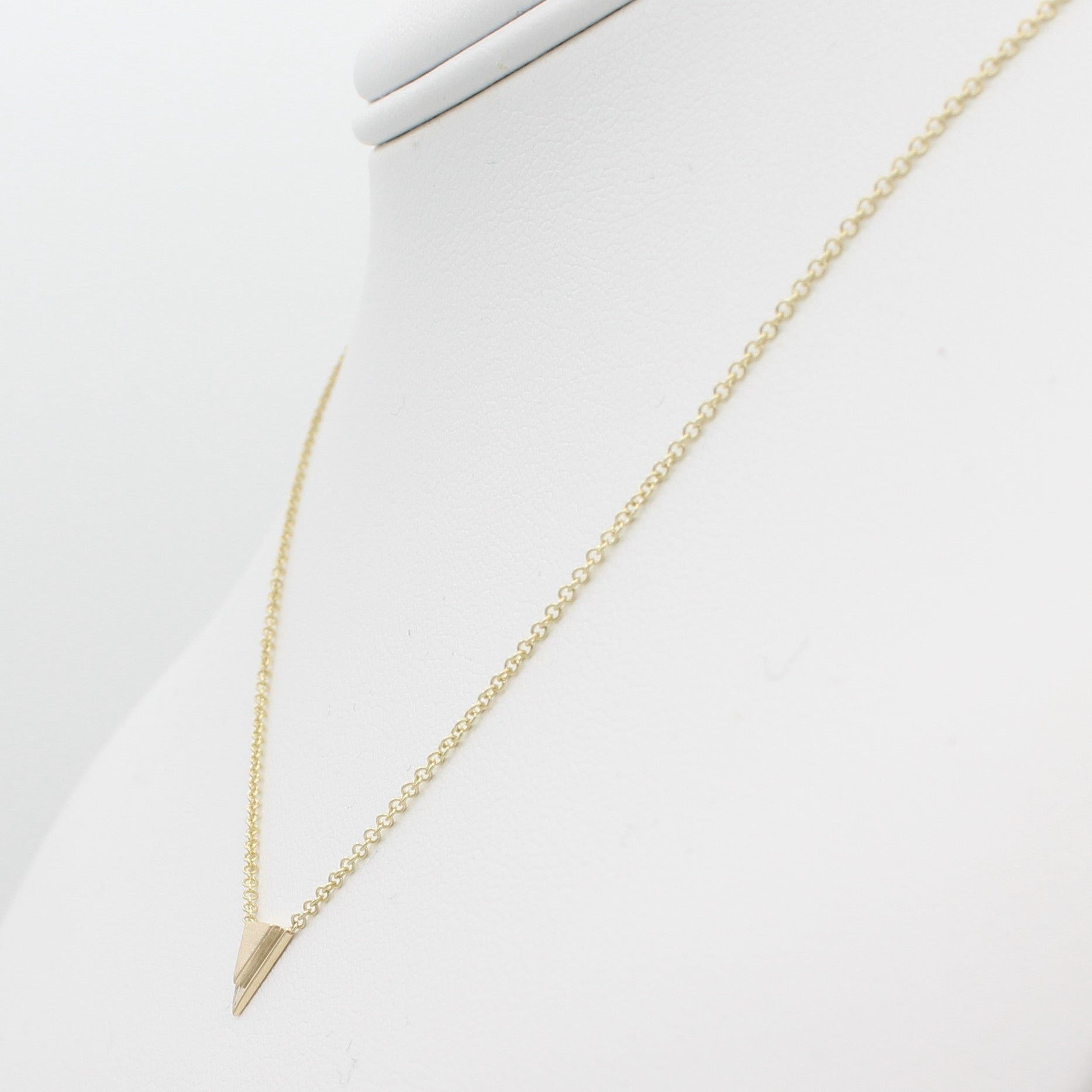 14k Yellow Gold Petite Double Triangle Single Station Pendant, right angle view of necklace displayed on a mannequin neckline. 