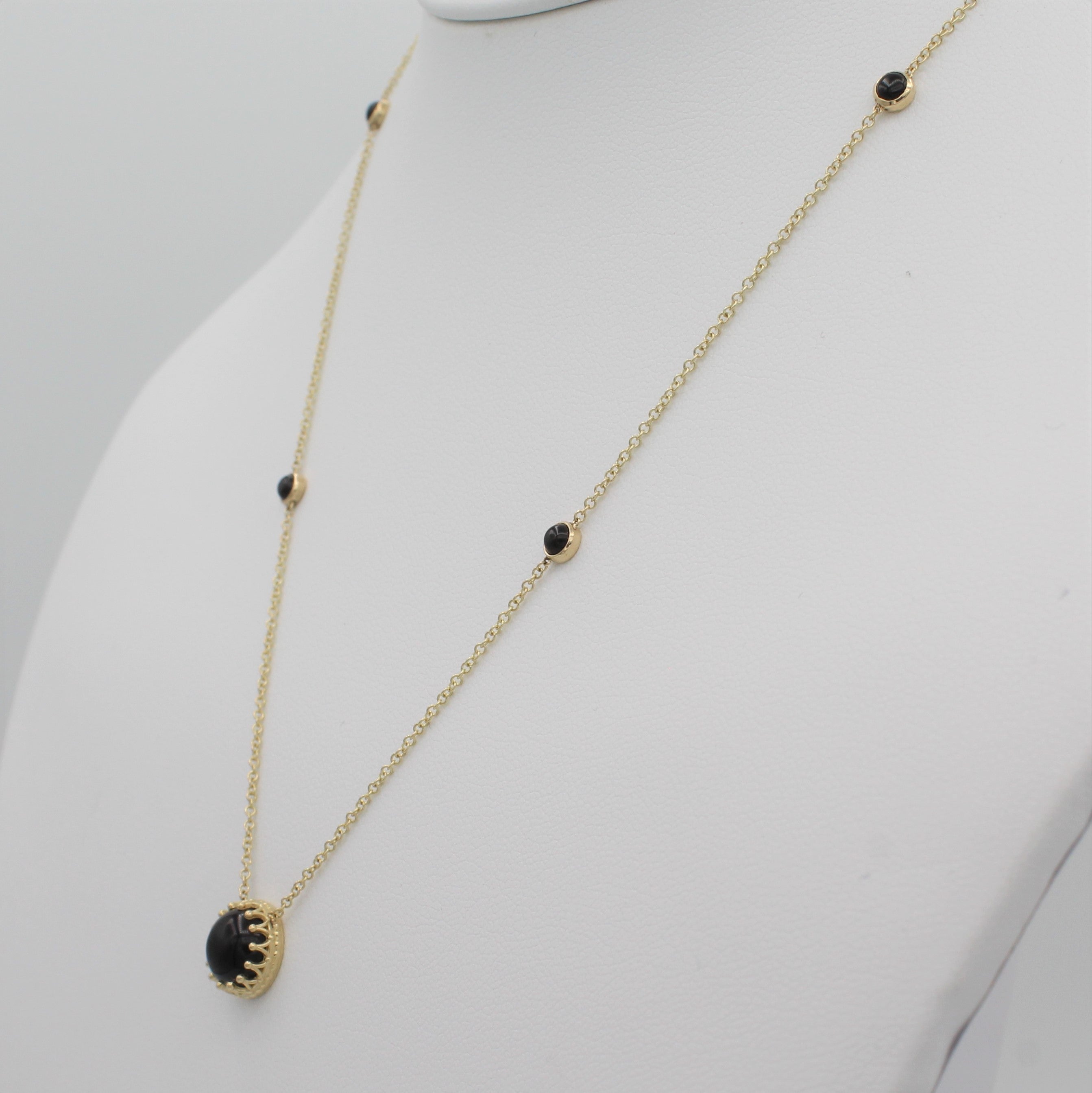 14k Yellow Gold Bewitched Black Onyx Station Necklace, right angle view of necklace displayed on a mannequin. 